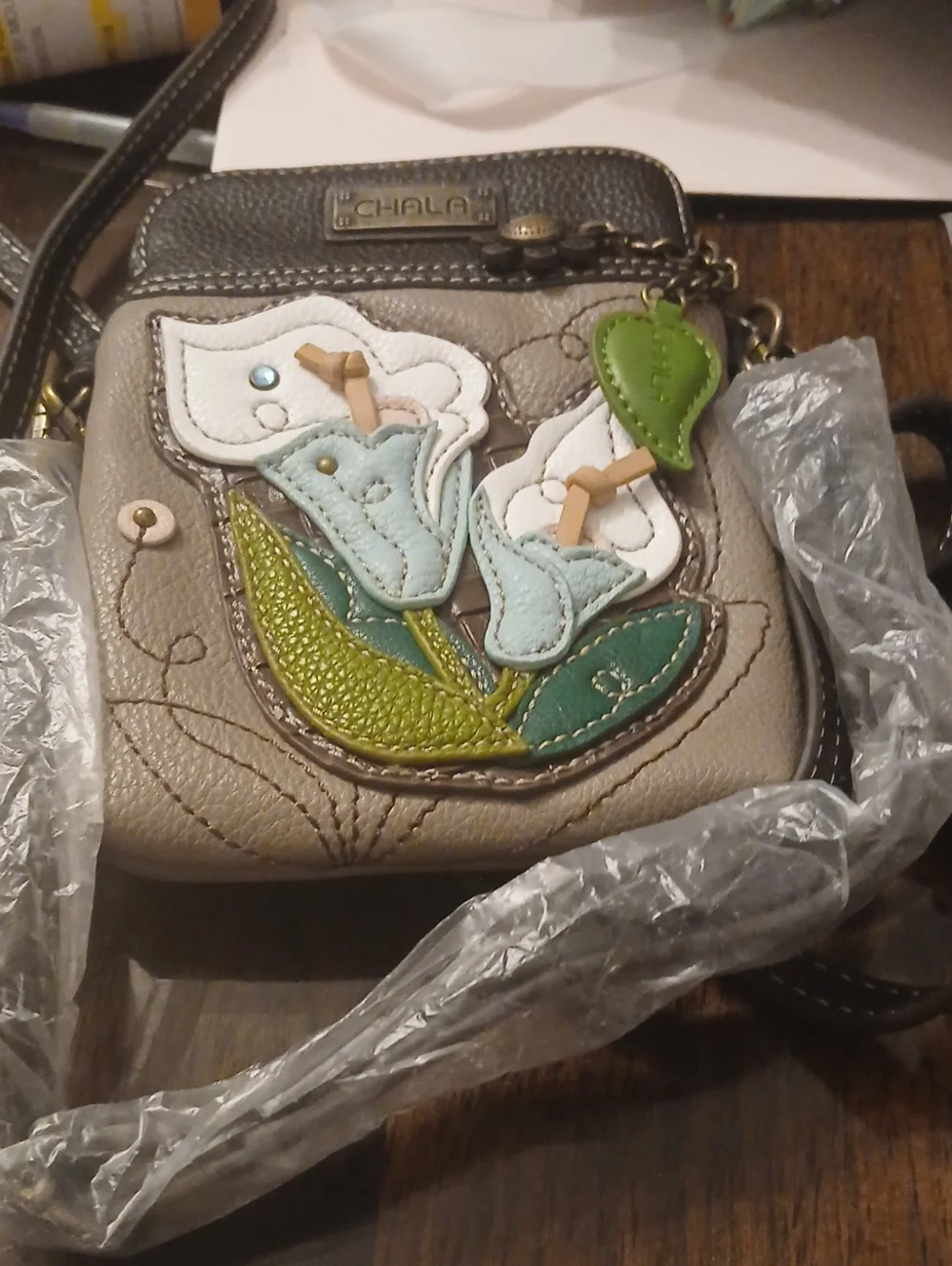 Chala Taupe Crossbody Bag with Blue, White & Green Floral Appliqué